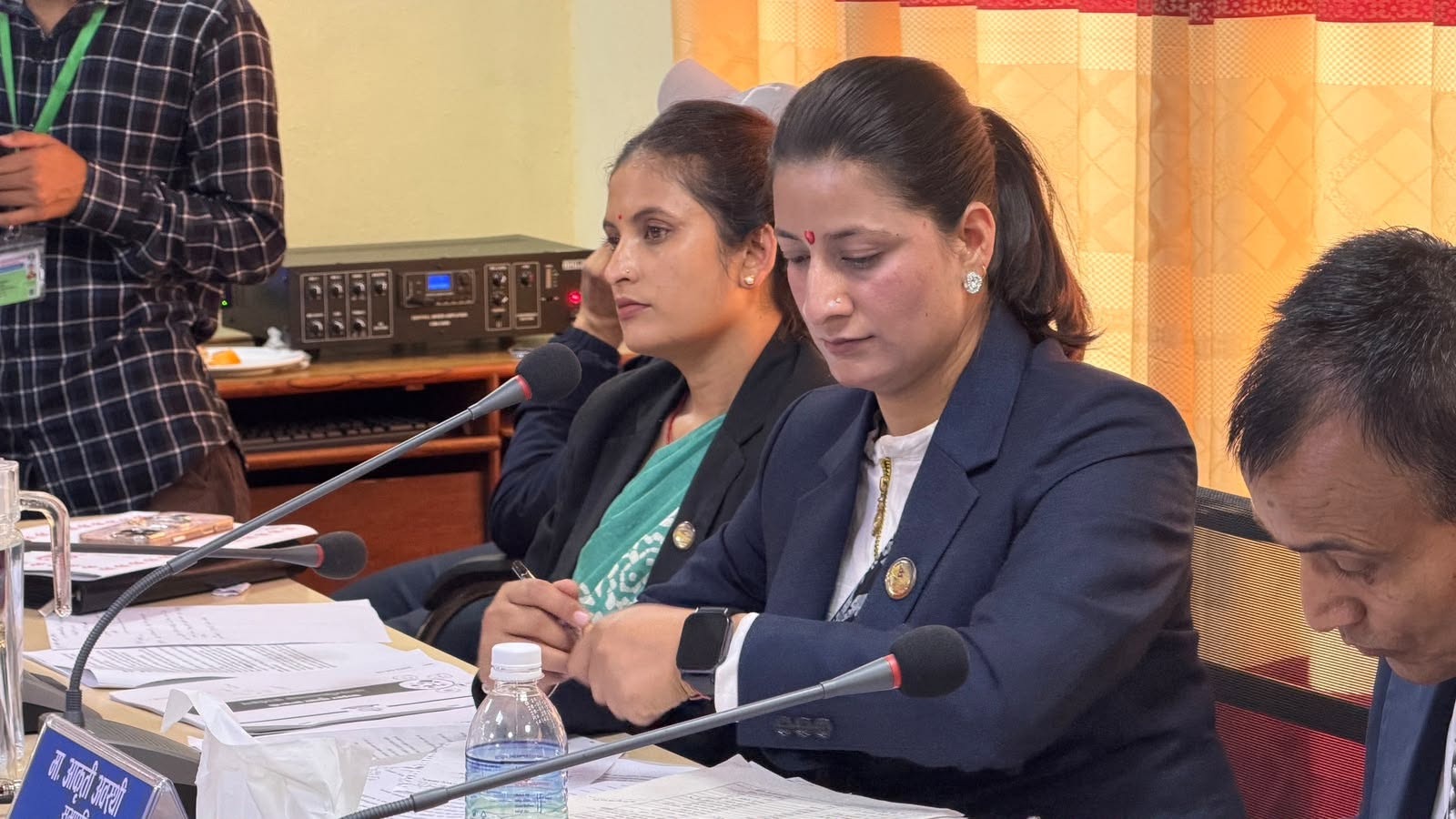 Aakriti Awasthi reviewing documents during the committee meeting