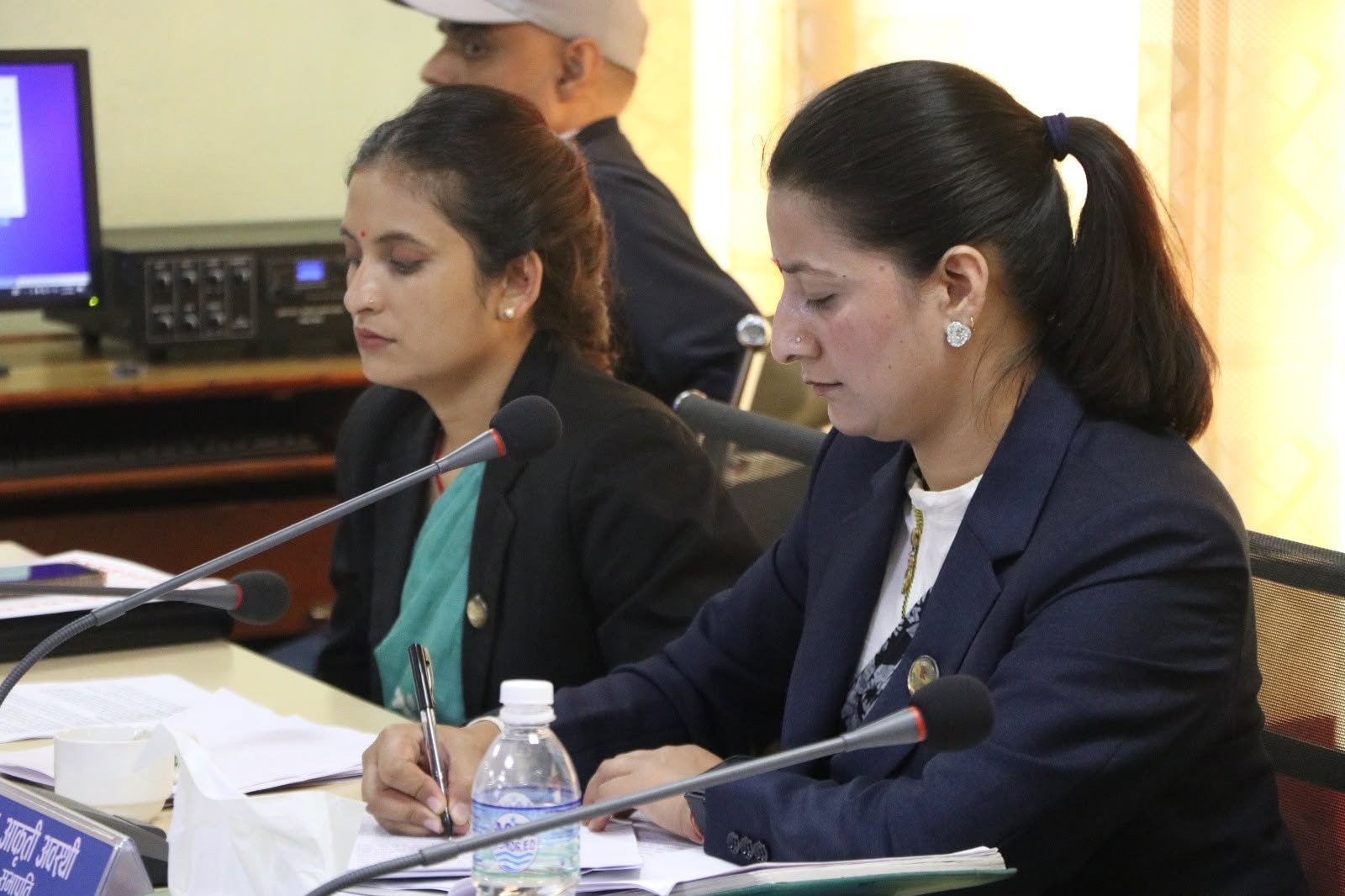Committee members taking notes during the cybersecurity meeting